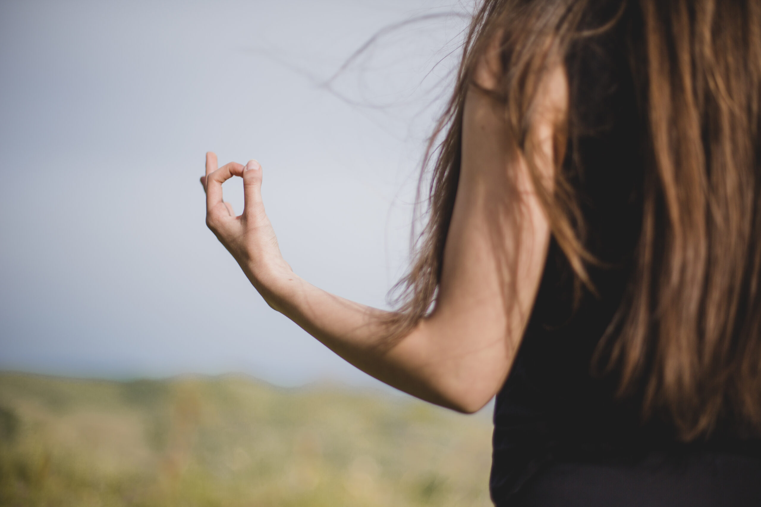 unrecognizable-girl-meditating-nature
